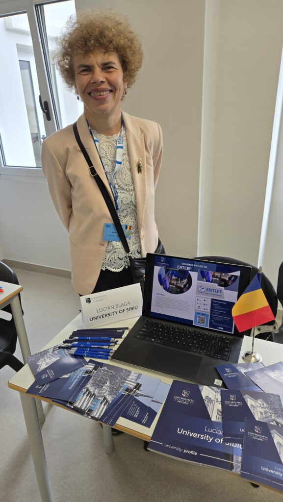 Prof. Dana Simian next to the stall with materials regarding Lucian Blaga University of Sibiu and ENTEEF project.