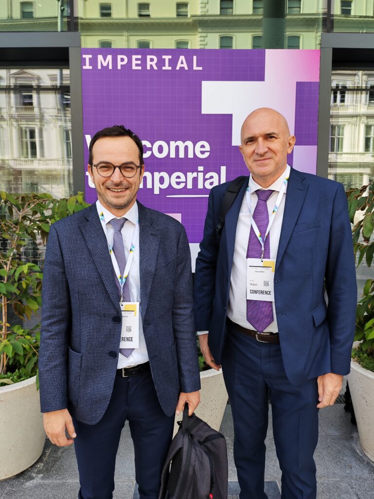 Professors Vladan Ivanović and Zoran Kalinić next to the ICL poster.