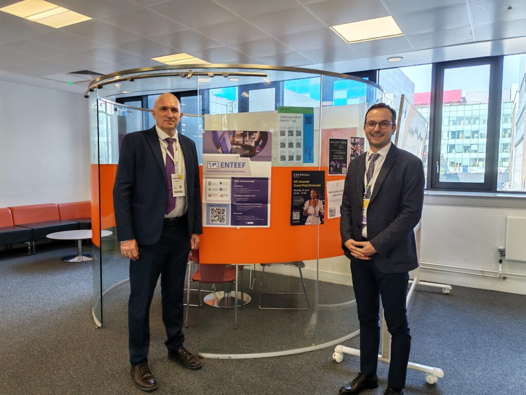 Professors Vladan Ivanović and Zoran Kalinić next to the ENTEEF poster.